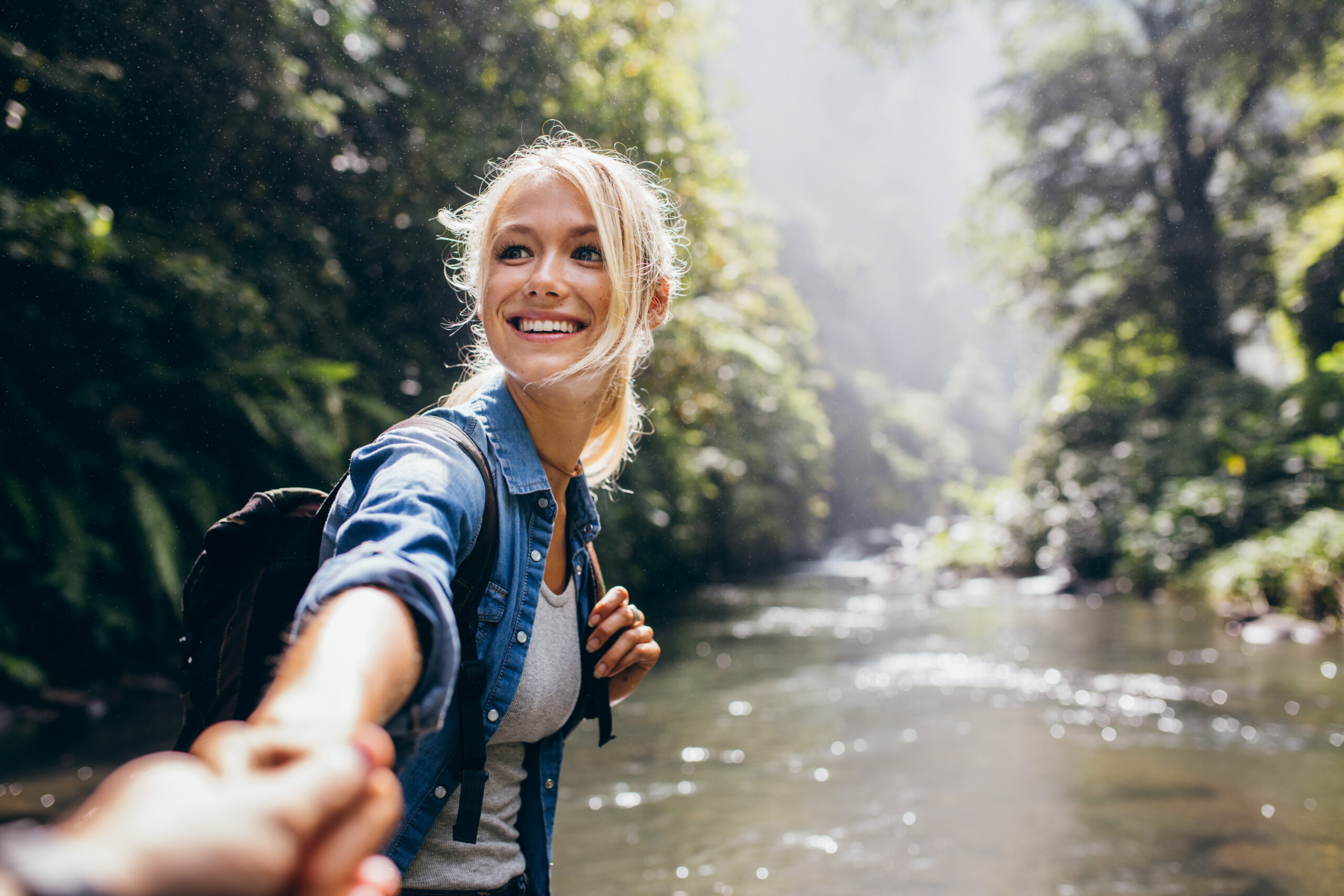 A woman by a stream, beginning to heal from trauma — EMDR and LENS neurofeedback at Aurora Village Therapy, Aurora, Ontario